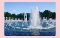 Photo of the World War II Memorial in Washington DC: A large fountain of water surrounded by white granite columns.