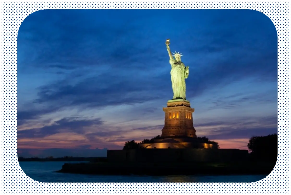 The Statue of Liberty, a green statue of a woman wearing long robes and holding a torch to the sky.