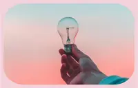 Hand holding light bulb.