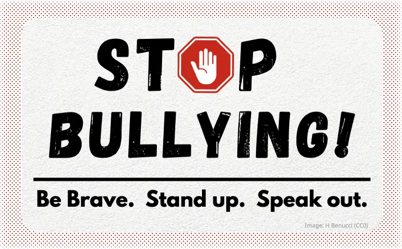 A sign says “Stop Bullying! Be brave, Stand up, Speak out.