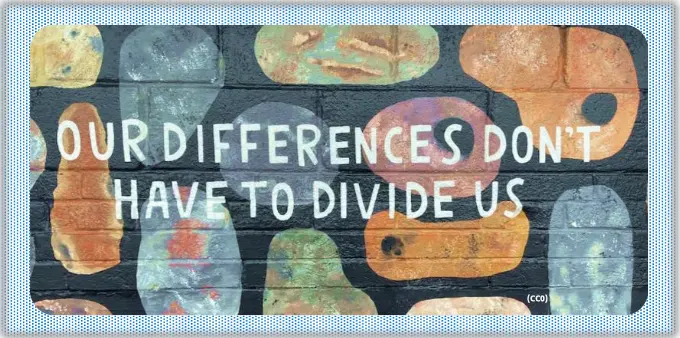 A colorful mural says the words “Our differences don’t have to divide us.”