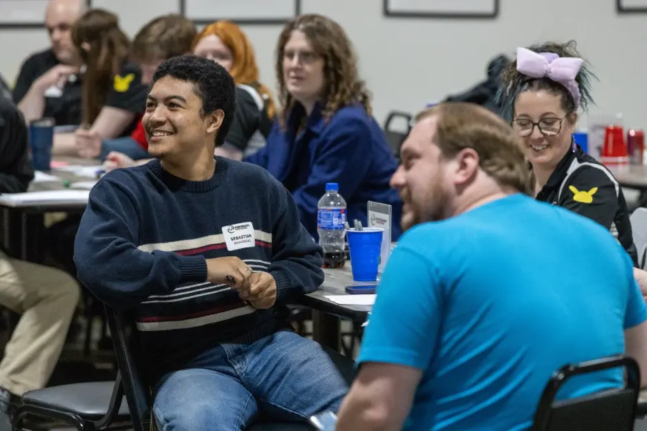 A
  group
  of
  people
  sitting
  at
  tables
  AI-generated
  content
  may
  be
  incorrect.