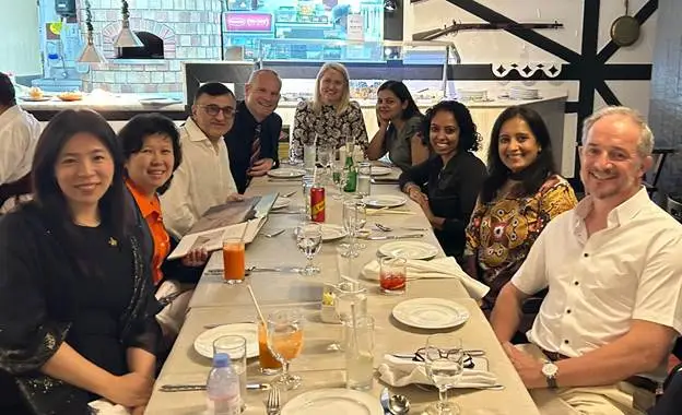 A
  group
  of
  people
  sitting
  at
  a
  long
  table
  AI-generated
  content
  may
  be
  incorrect.